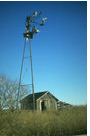 old wood barn with a tall windmill
