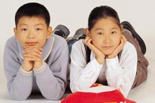 two Asian looking kids, boy on the left and girl on the right. They are not twins.