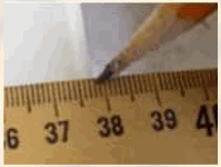 A picture of the tip of a pencil pointing to a meter stick indicating a measurement of 37.9 cm.